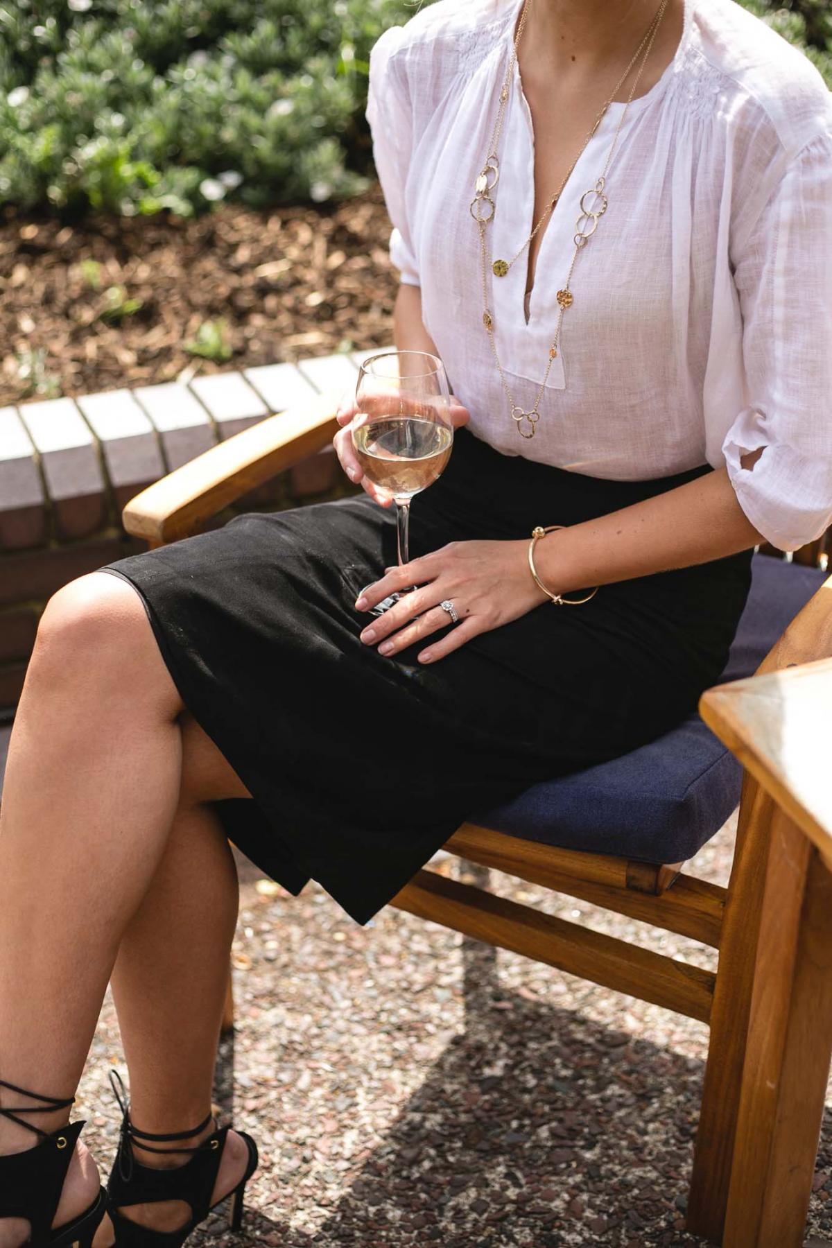 Jaeger white linen shirt, gold disc necklace, gold knot bracelet, black suede pencil skirt