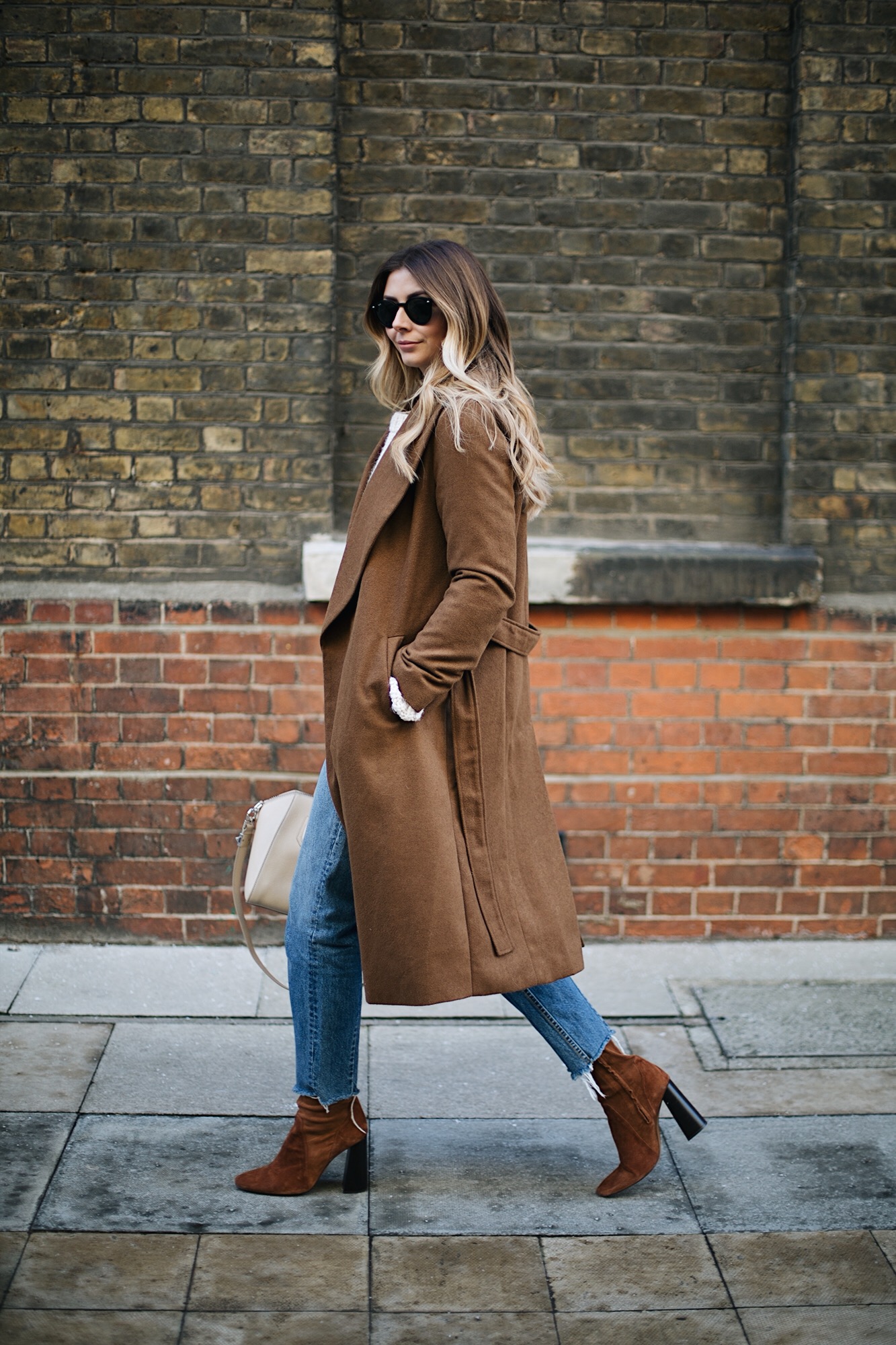 Emma Hill wears Tan coat, cream sweater, frayed hem jeans, givenchy antigona small ivory, tan suede boots, winter outfit