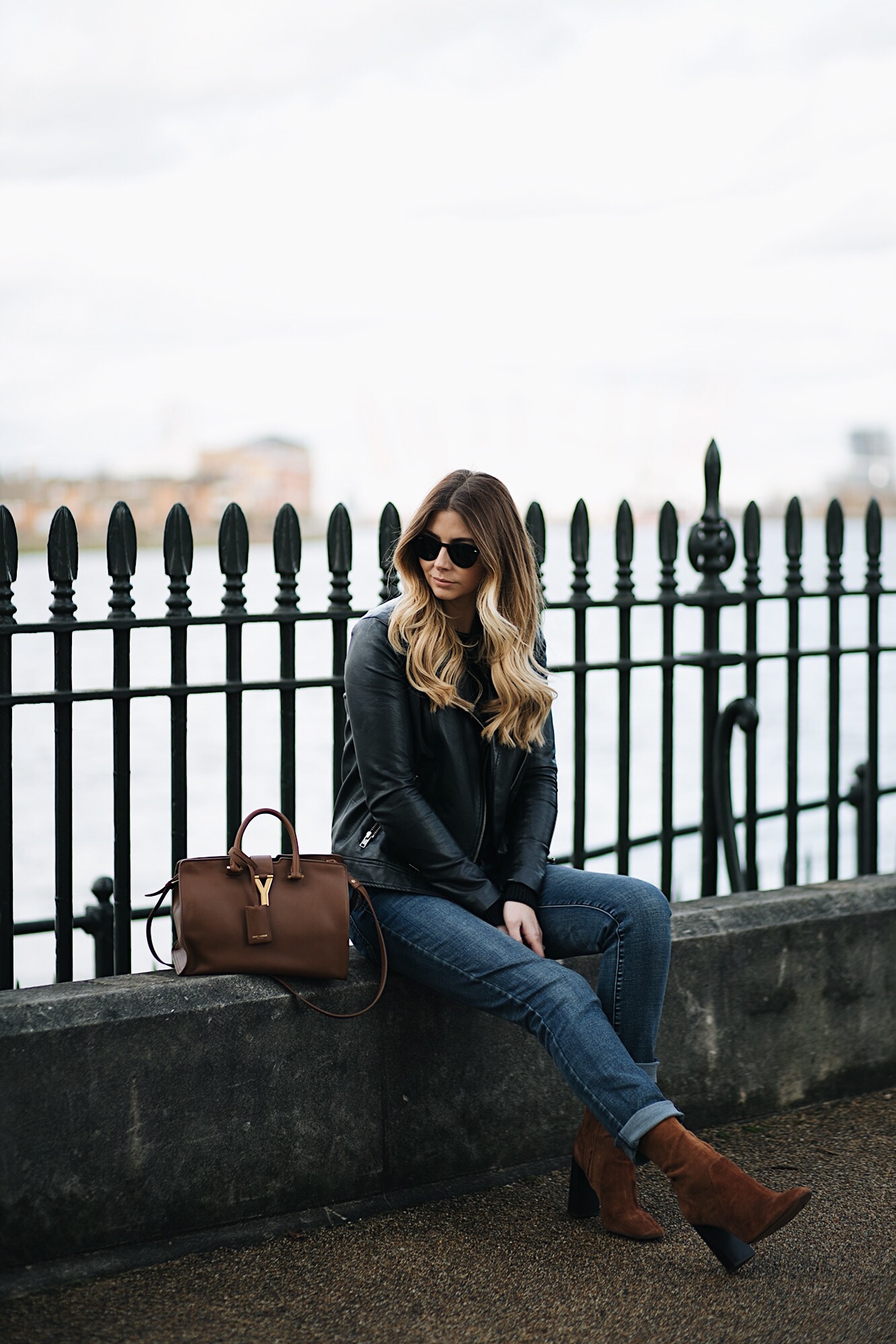 black leather biker jacket, black sweater, dark wash boyfriend jeans, tan suede ankle sock boots, tan YSL Saint Laurent Chic Cabas, winter outfit