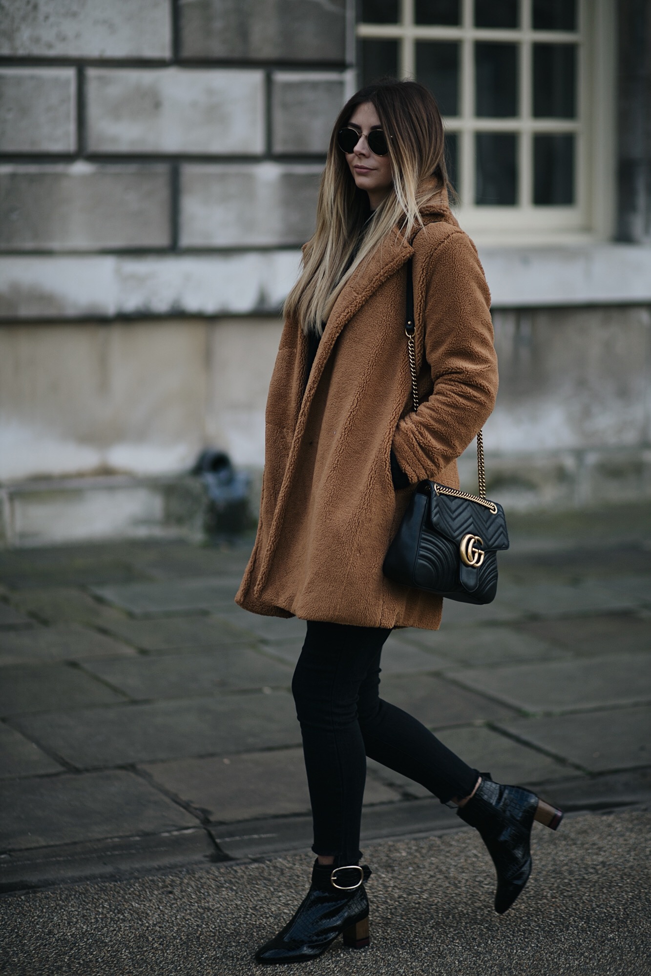 Emma Hill wears camel brown teddy bear coat, Gucci medium black leather Marmont bag, black skinny frayed hem jeans, black patent ankle boots, winter outfit
