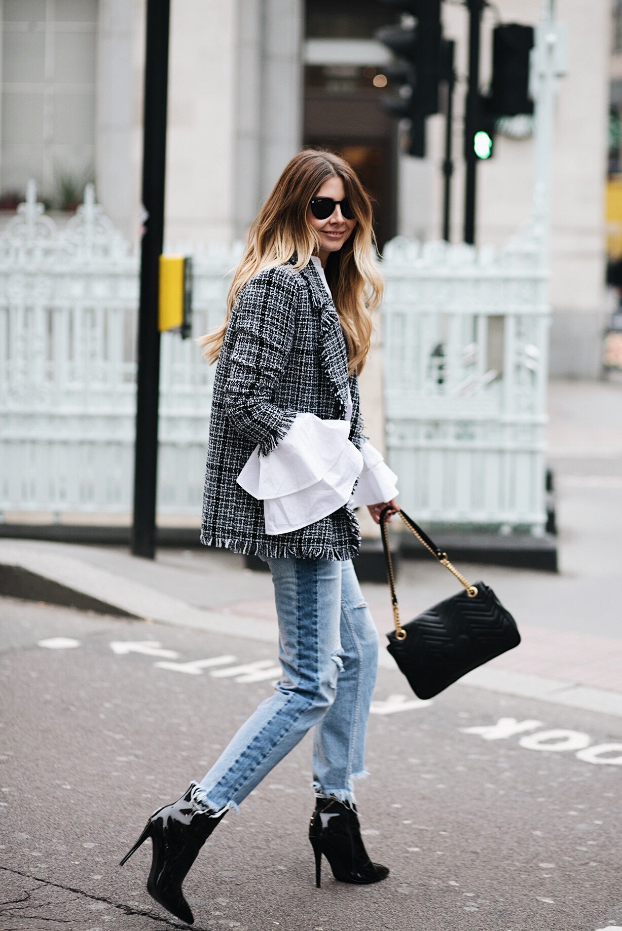 Emma Hill (EJStyle) wears boucle tweed blazer, flare ruffle cuff white shirt, light wash denim stepped hem frayed jeans, Gucci Marmont bag, black pic vinyl ankle boots, London street style