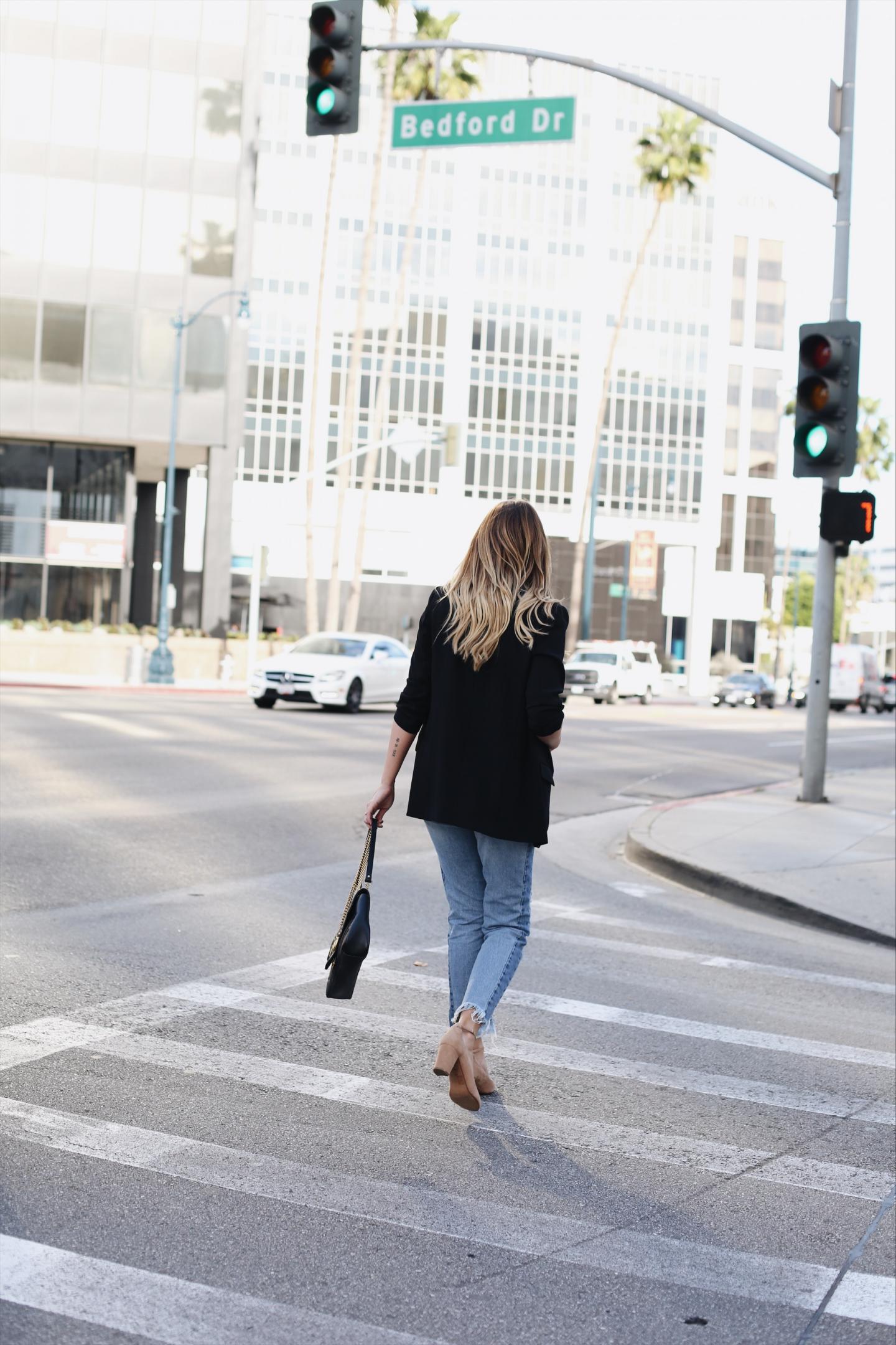 LA street style Emma Hill EJStyle wears pink velvet came top, black blazer, bleach wash ripped jeans, Gucci Marmont bag in LA