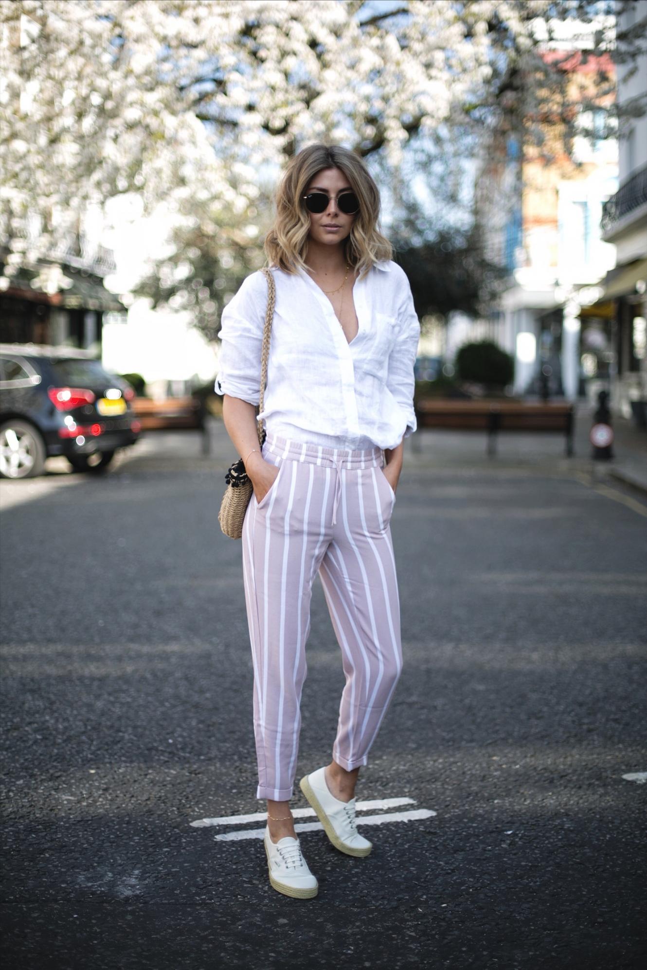Emma Hill wears pink stripe trousers, white linen shirt, woven basket bag, Vans espadrille lace ups, Ray Ban round metal sunglasses, casual spring summer outfit