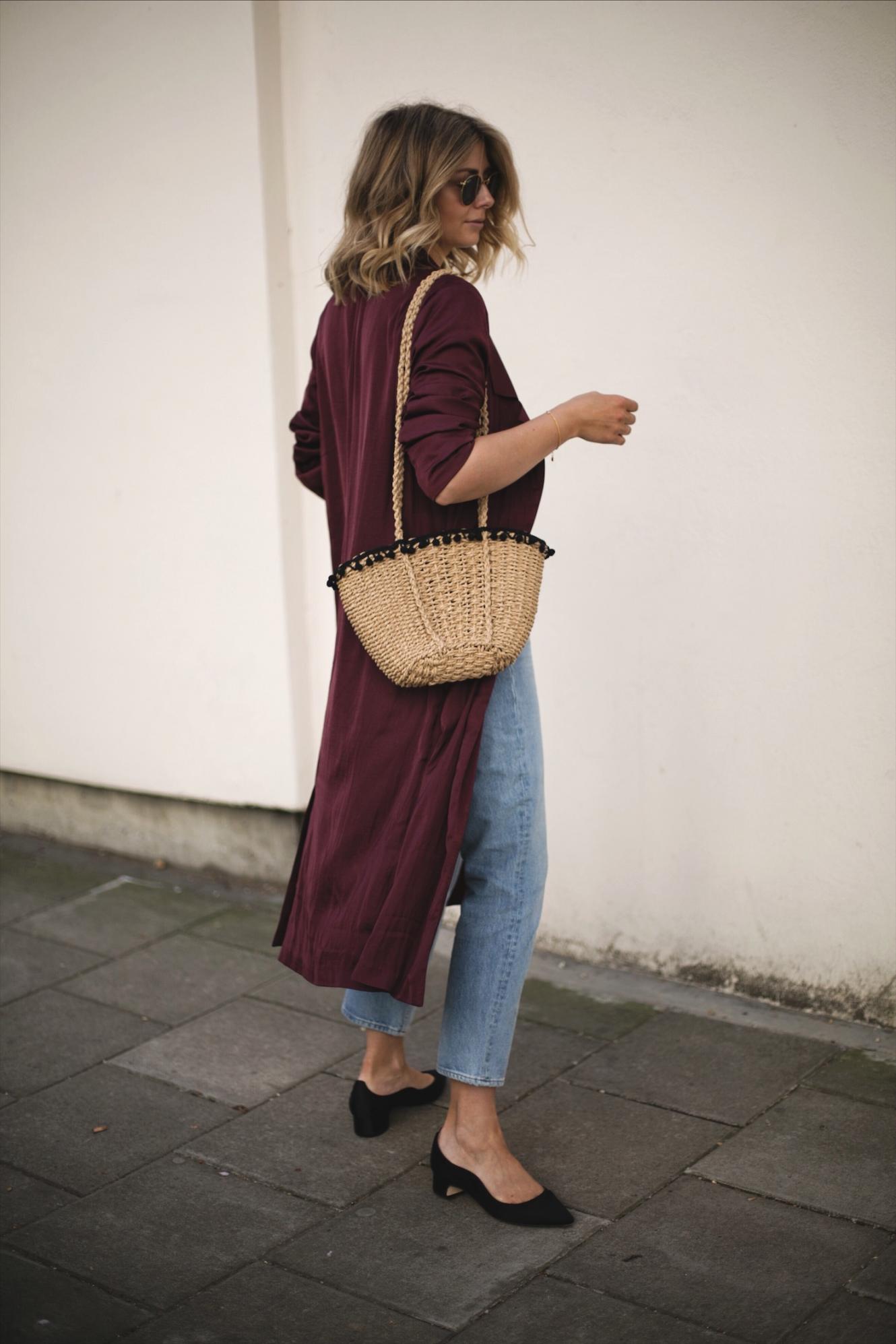 Emma Hill wears deep purple wine silky duster jacket kimono, straw basket bag with pom pom detail, cropped frayed hem jeans, Dune x Rupert Sanderson low block heels, outfit ideas for Spring