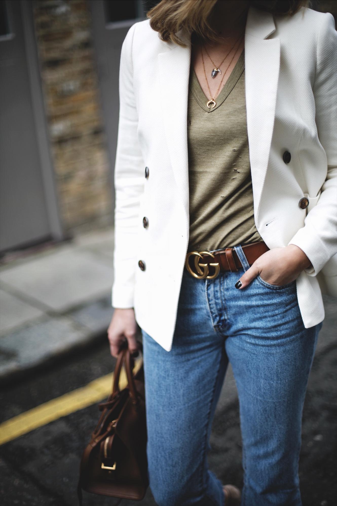 Emma Hill wears off white double breasted blazer, khaki nibbled t-shirt, frayed hem cropped jeans, tan leather Gucci Marmont belt GG, gold Missoma necklaces, YSL Saint Laurent Cabas Chyc in tan leather, chic spring outfit