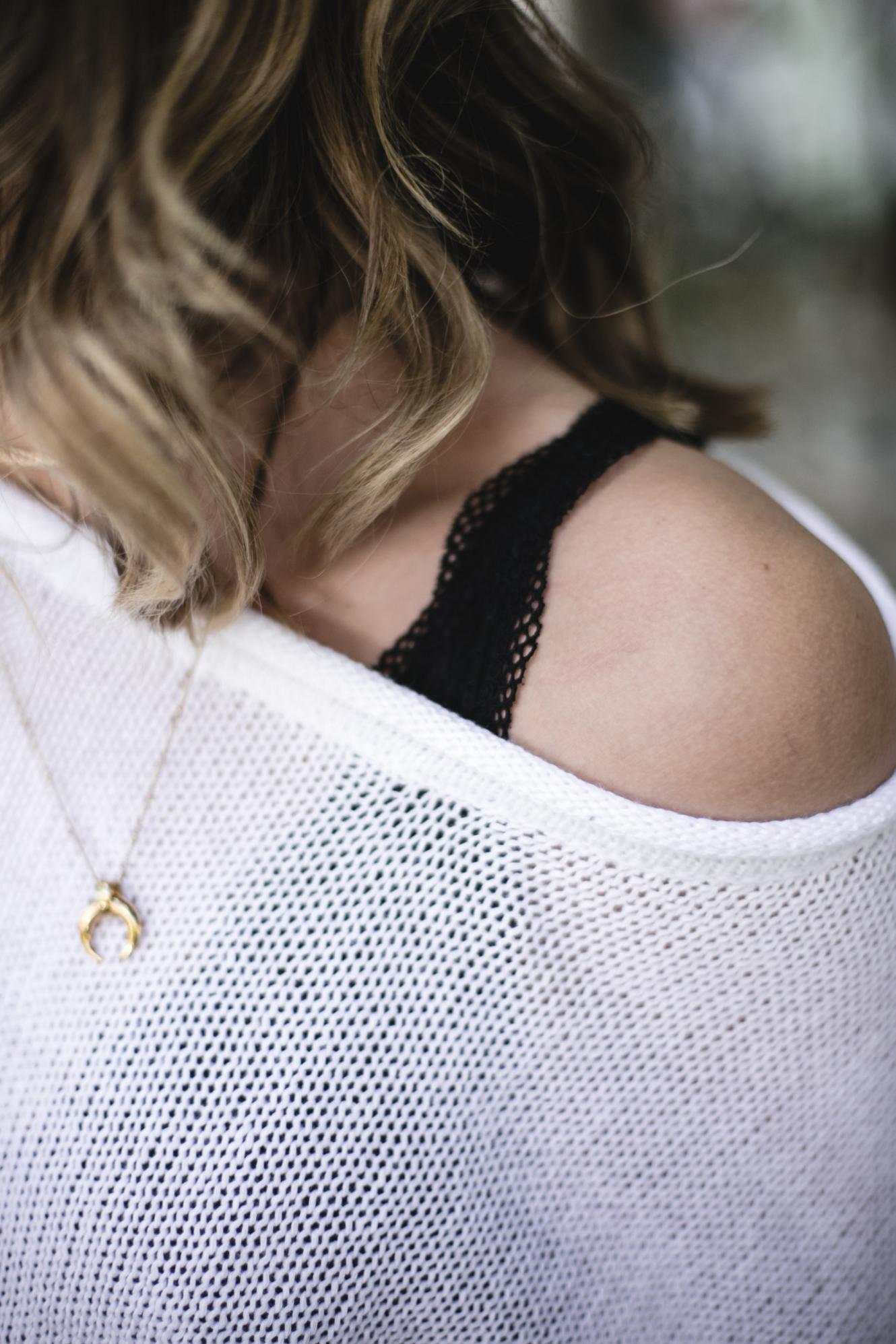 black lace bra, white off the shoulder knit jumper, gold horn necklace