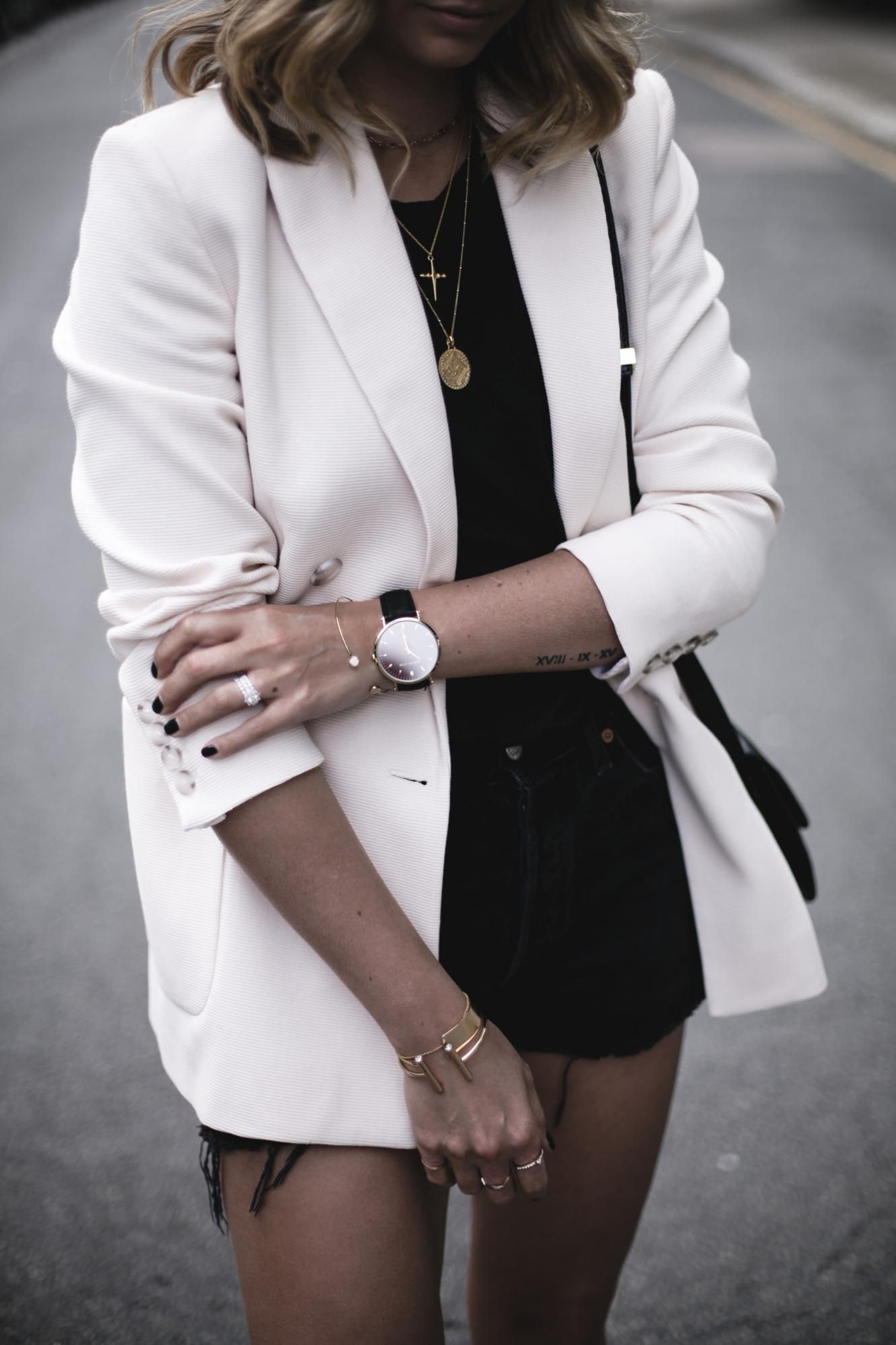 Emma Hill wears cream double breasted blazer, black vintage Levis 501 shorts, black t-shirt, layered gold necklaces, Celine box bag, chic summer outfit