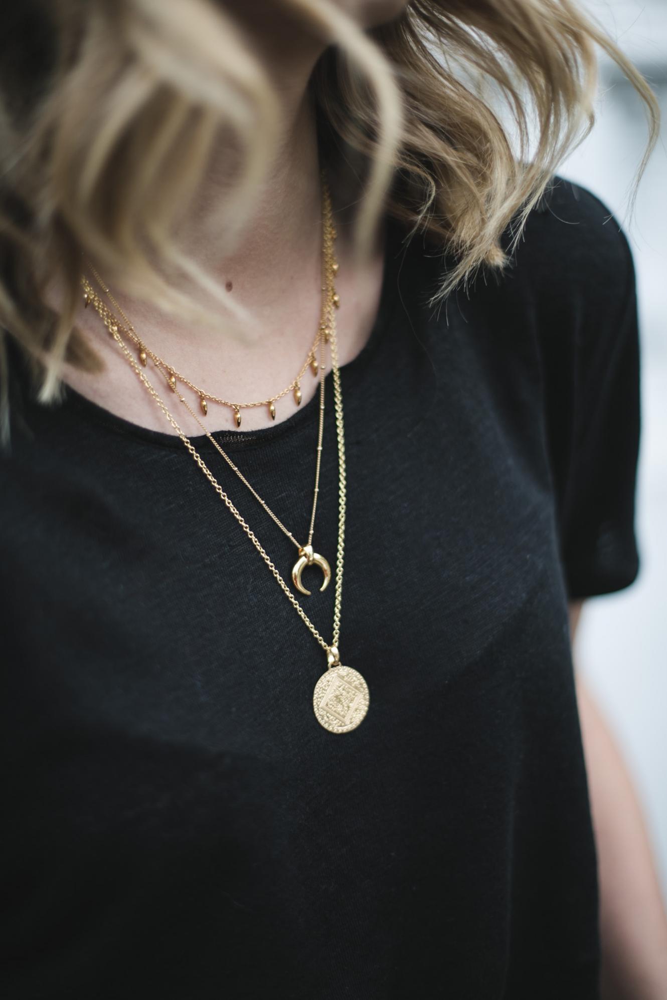 Black t-shirt, lob hair layered gold necklaces Black t-shirt, lob hair layered gold necklaces