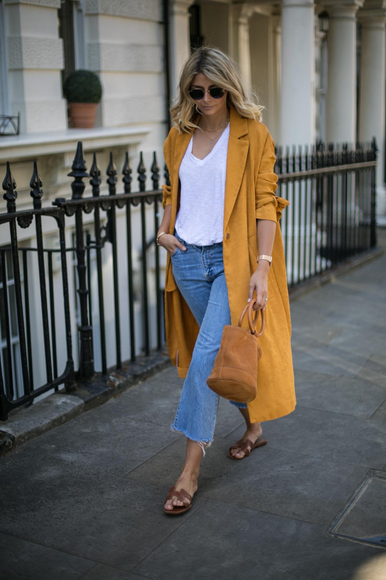 Emma Hill wears Mustard duster coat, cropped frayed jeans, Hermes Oran tan leather sandals, basic white t shirt, Simon Miller Bonsai bag, summer outfit