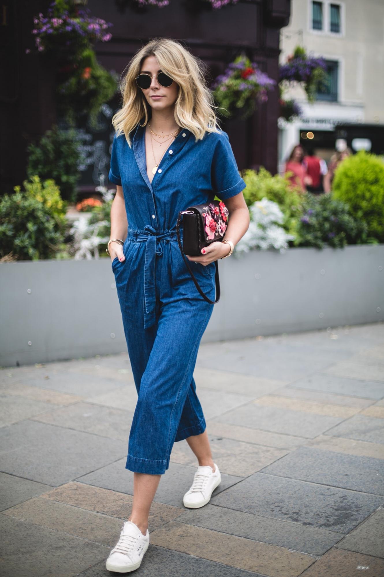 Emma Hill wears denim jumpsuit, floral handbag, YSL trainers, casual summer outfit