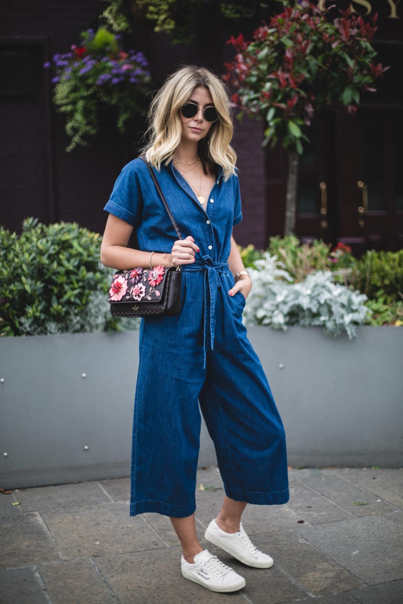 Emma Hill wears denim jumpsuit, floral handbag, YSL trainers, casual summer outfit