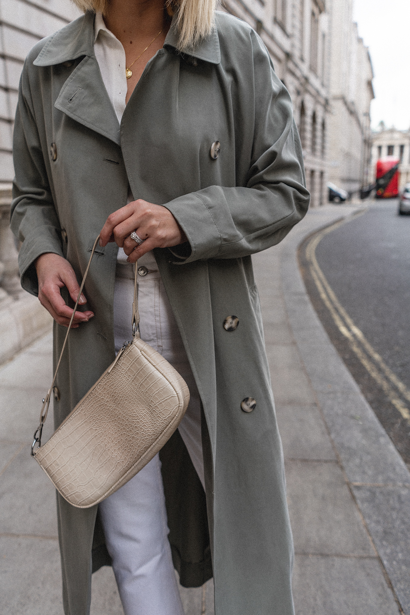 Emma Hill style, mint green trench coat, button up collared shirt, mock croc cream baguette bag, white jeans, gold necklace, Spring outfit ideas