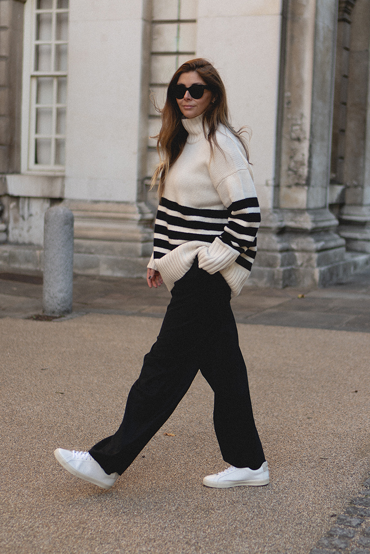 BLOG Emma Hill style. Black & white stripe chunky sweater jumper, black wide leg tailored wool trousers. Celine Seau Sangle bag, white trainers, Celine sunglasses. Chic and minimal autumn fall outfit
